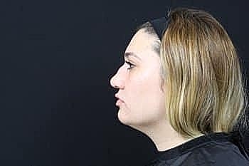 Profile view of a woman with light hair.