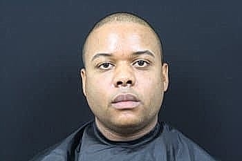 Portrait of a man with a black background.