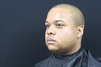 Man with short hair in barber chair.