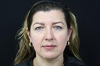 Woman with long hair against a dark background