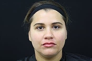 Portrait of a woman against a dark background.