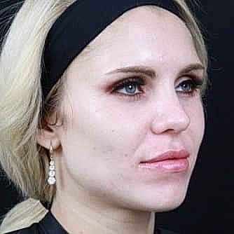 Close-up portrait of a woman with earrings.