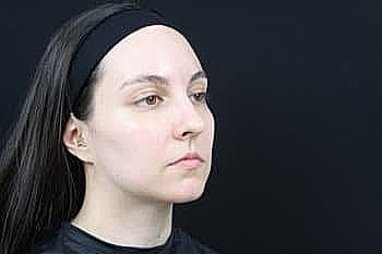 Woman with long hair against dark background