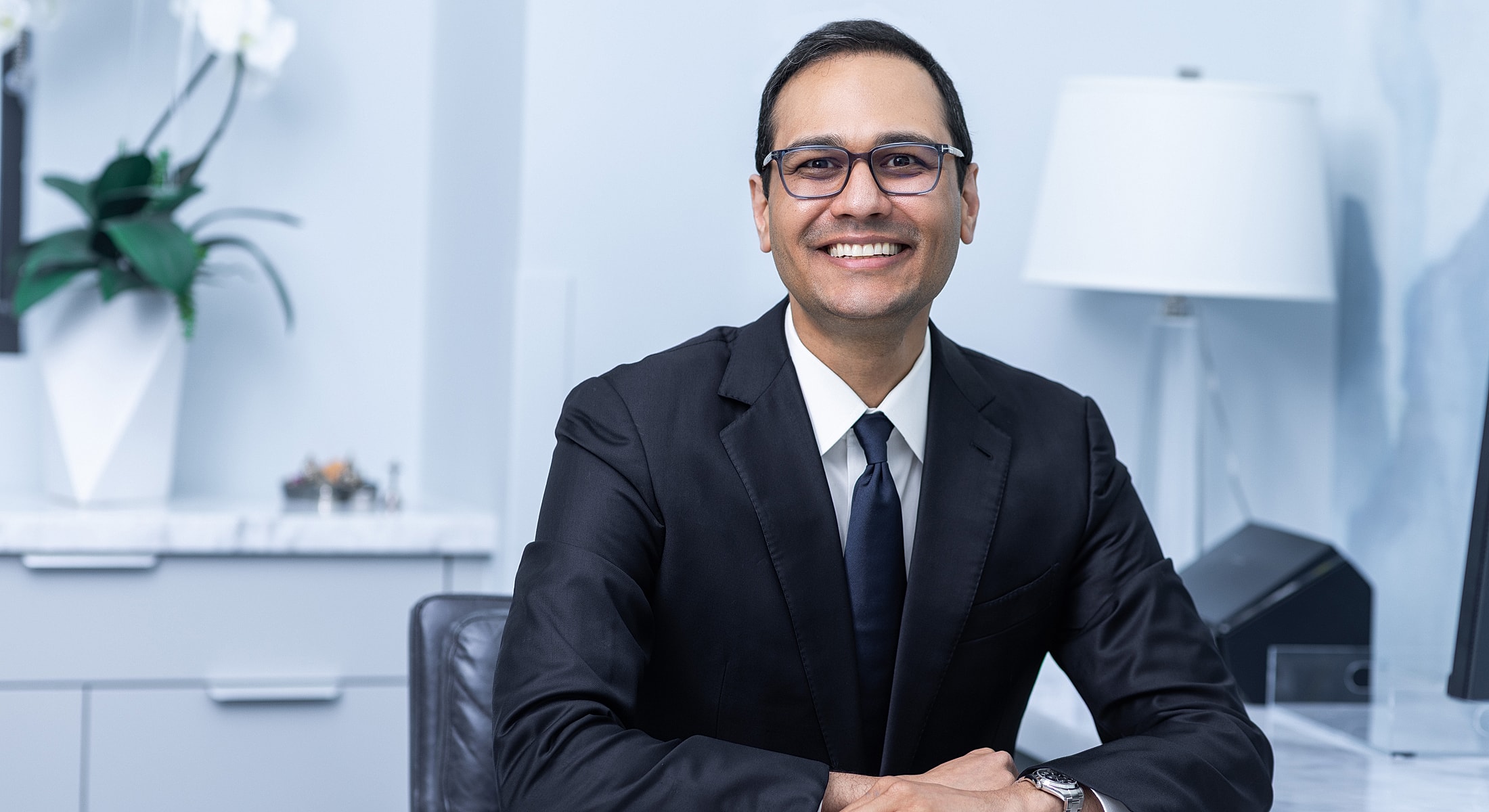 Professional man smiling in an office setting.