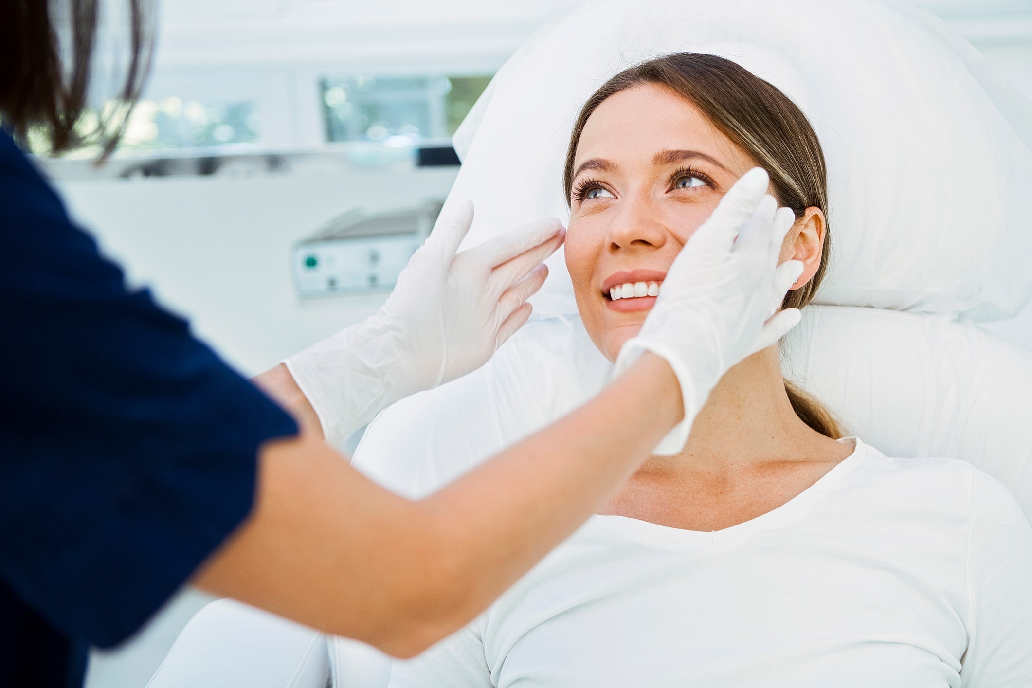 Patient receiving skincare treatment in clinic.