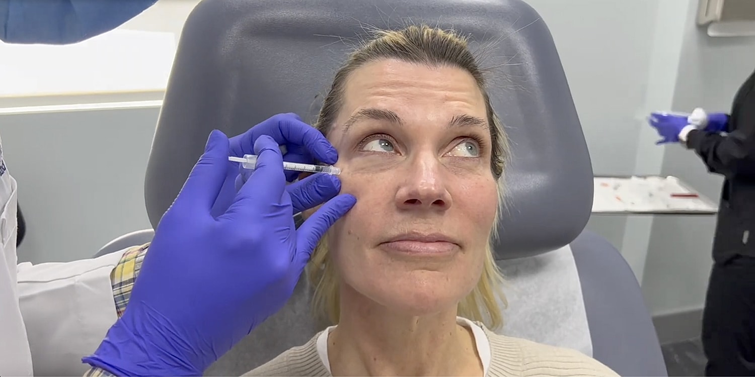 Facial treatment session in progress with device.