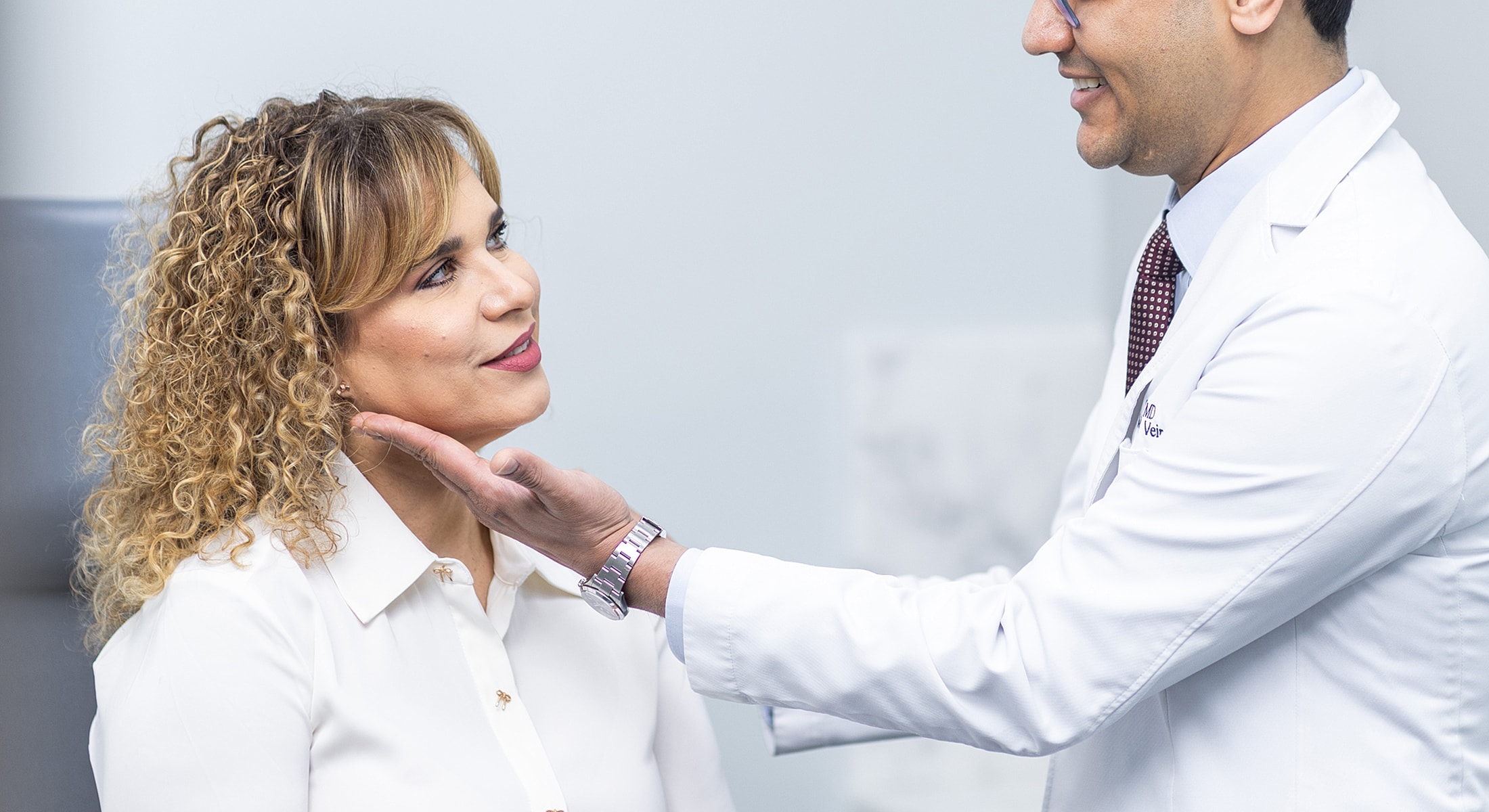 Patient consultation in medical office setting.