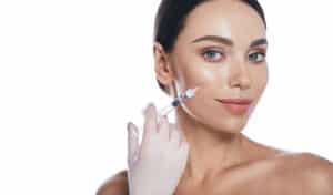 A woman getting cheek fillers for buccal fat removal regret in Coral Gables